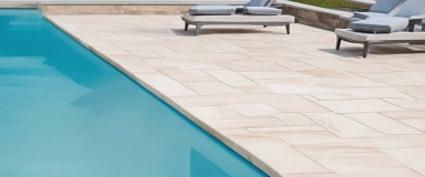 Ocean Sand Pavers featuring a light sandy color with a smooth finish, perfect for creating bright and coastal-inspired outdoor patios and walkways.